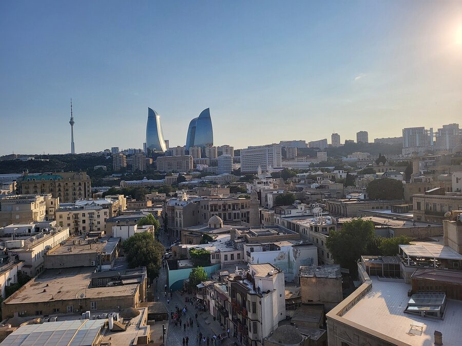 Panoramic view of Baku skyline with the medieval Maiden Tower in the foreground and modern towers behind
